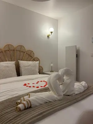 a rendering of a bed with a woman laying on it at Suite orientale avec baignoire balnéo in Cagnes-sur-Mer