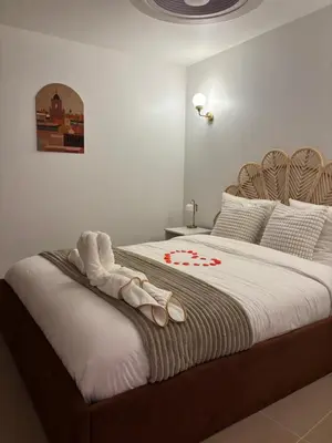 a bedroom with a bed with two towels on it at Suite orientale avec baignoire balnéo in Cagnes-sur-Mer