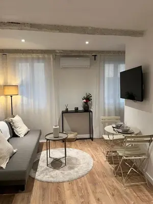a living room with a couch and a table at Appartement cosy au coeur du vieux Nice in Nice