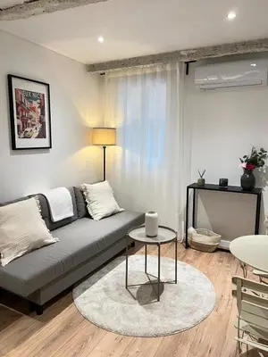 a living room with a couch and a table at Appartement cosy au coeur du vieux Nice in Nice