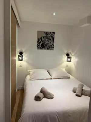 a bedroom with a bed with two towels on it at Appartement cosy au coeur du vieux Nice in Nice