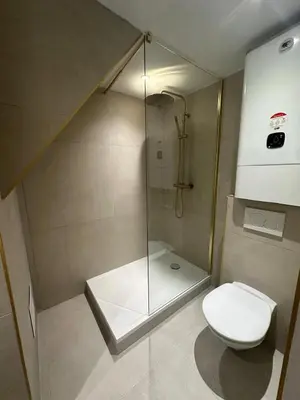 a bathroom with a toilet and a glass shower at Appartement cosy au coeur du vieux Nice in Nice