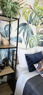 a bedroom with a mural of palm trees at Luxe Apartements Azur in Nice