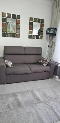 a brown couch in a living room with mirrors at Luxe Apartements Azur in Nice