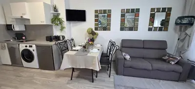 a living room with a table and a couch at Luxe Apartements Azur in Nice