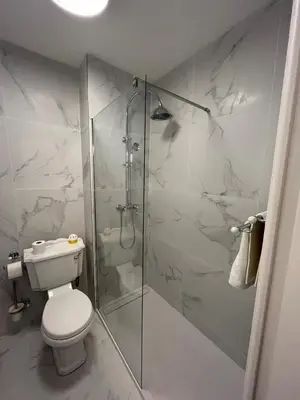 a bathroom with a toilet and a glass shower at Charmant 2 pièces - Hyper Centre de Nice in Nice