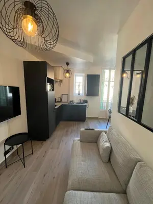 a living room with a couch and a table at Charmant 2 pièces - Hyper Centre de Nice in Nice