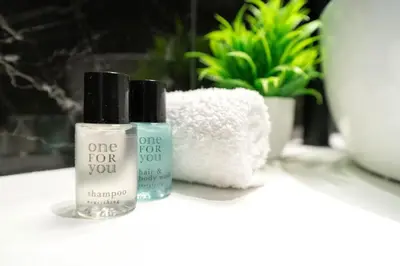 two bottles of one for you products sitting on a counter at Romantic suite with jacuzzi in La Trinité