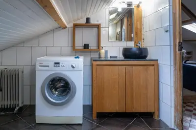 a kitchen with a washing machine and a sink at Appart' cosy sur les toits du coeur de Nice - Clim in Nice