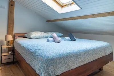 a bedroom with a bed with pillows and a window at Appart' cosy sur les toits du coeur de Nice - Clim in Nice