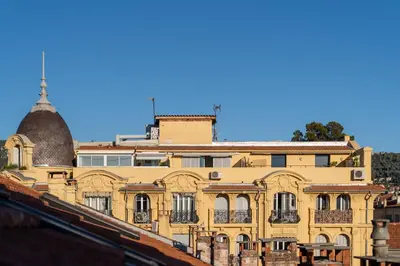 a yellow building with a dome on top of it at Appart' cosy sur les toits du coeur de Nice - Clim in Nice