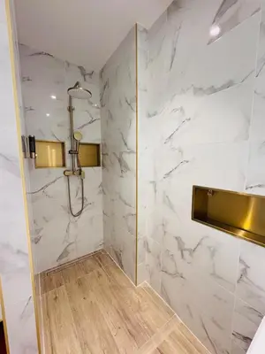 a bathroom with white marble walls and a shower at LE PALAIS DIANE - Apt cosy, Moderne et Climatisé in Nice