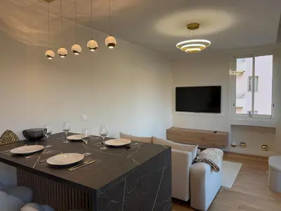 a living room with a table with wine glasses on it at LE PALAIS DIANE - Apt cosy, Moderne et Climatisé in Nice