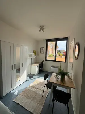 a room with a desk and a table and a window at Bright studio in Nice - Mobility lease only - WIFI in Nice