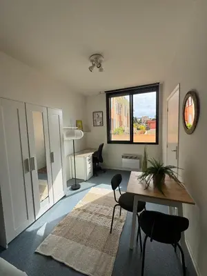 a room with a table and chairs and a window at Bright studio in Nice - Mobility lease only - WIFI in Nice