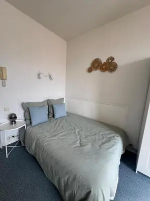 a bedroom with a bed with a butterfly on the wall at Bright studio in Nice - Mobility lease only - WIFI in Nice