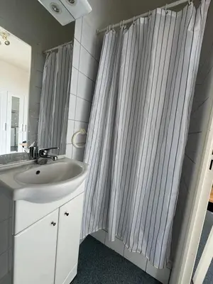 a bathroom with a sink and a shower curtain at Bright studio in Nice - Mobility lease only - WIFI in Nice