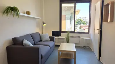 a living room with a blue couch and a table at LX137 1-Bedroom - Downtown Nice - Mobility Lease in Nice