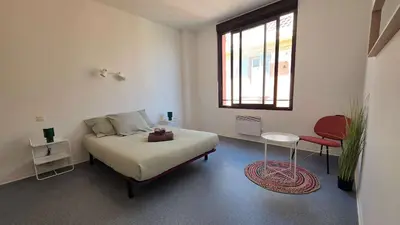a bedroom with a bed and a table and a window at LX137 1-Bedroom - Downtown Nice - Mobility Lease in Nice
