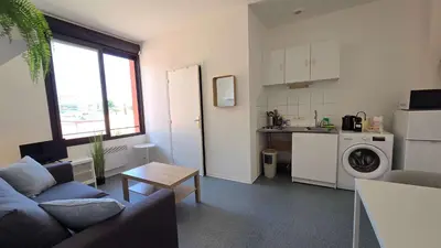 a living room with a couch and a kitchen at LX137 1-Bedroom - Downtown Nice - Mobility Lease in Nice