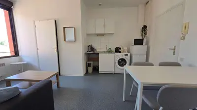 a living room with a table and a kitchen at LX137 1-Bedroom - Downtown Nice - Mobility Lease in Nice