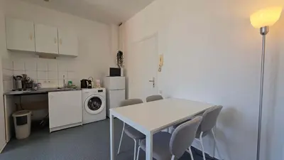 a kitchen with a white table and chairs in a room at LX137 1-Bedroom - Downtown Nice - Mobility Lease in Nice