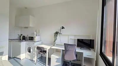 a white kitchen with a desk and a microwave at LX144 Bright & refined studio WIFI Mobility lease in Nice
