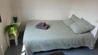 a bed with a purple box on top of it at LX144 Bright & refined studio WIFI Mobility lease in Nice