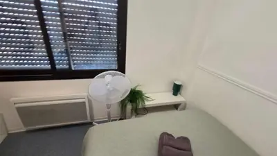 a bedroom with a fan and a window at LX144 Bright & refined studio WIFI Mobility lease in Nice