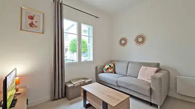 a living room with a couch and a table at LX148 Charmant studio renove Tram - Bail mobilite in Nice