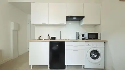 a kitchen with a washing machine and a microwave at LX148 Charmant studio renove Tram - Bail mobilite in Nice