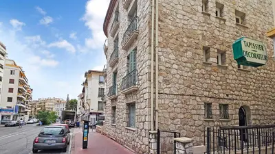 a car parked next to a stone building on a street at LX148 Charmant studio renove Tram - Bail mobilite in Nice