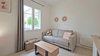 a living room with a couch and a table at LX148 Charmant studio renove Tram - Bail mobilite in Nice
