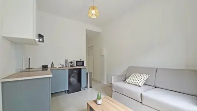 a living room with a couch and a kitchen at LX149 Studio lumineux fonctionnel - Bail mobilite in Nice