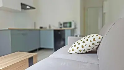 a polka dot pillow sitting on a couch at LX149 Studio lumineux fonctionnel - Bail mobilite in Nice