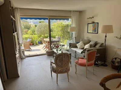 a living room with a couch and chairs and a patio at Appartement 2 chambres, terrasses, proche mer et commerces à Saint-Jean Cap Ferrat in Saint-Jean-Cap-Ferrat