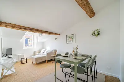 a living room with a green table and chairs at Port de Nice - Cosy flat - 1 bed - AC in Nice