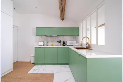 a kitchen with green cabinets and a sink at Port de Nice - Cosy flat - 1 bed - AC in Nice