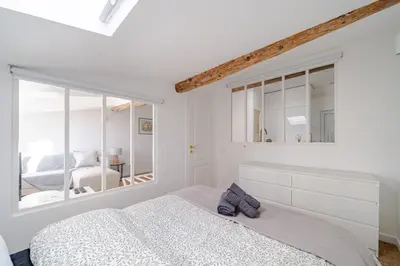 a white bedroom with a bed and a window at Port de Nice - Cosy flat - 1 bed - AC in Nice