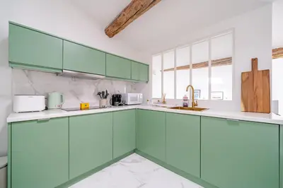 a kitchen with green cabinets and a sink at Port de Nice - Cosy flat - 1 bed - AC in Nice
