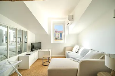 a white living room with a couch and a television at Port de Nice - Cosy flat - 1 bed - AC in Nice