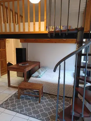 a bedroom with a bunk bed and a stair case at Studio in Nice