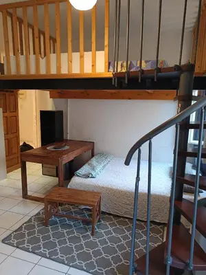 a room with a bunk bed and a desk at Studio in Nice