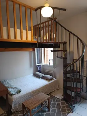 a bedroom with a bunk bed and a staircase at Studio in Nice