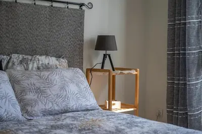 a bedroom with a bed and a lamp on a table at louna in Beaulieu-sur-Mer