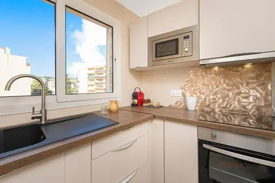 a kitchen with a sink and a microwave at Nice Saint Roch - Bel appartement rénové - EV in Nice