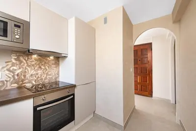 a kitchen with a stove and a microwave at Nice Saint Roch - Bel appartement rénové - EV in Nice