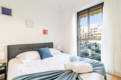 a living room with a couch and a tv at Ultra Central 2 Bdr - AC & Balcony in Nice