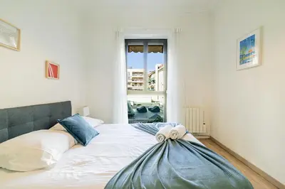 a bedroom with a bed with orange and white pillows at Ultra Central 2 Bdr - AC & Balcony in Nice