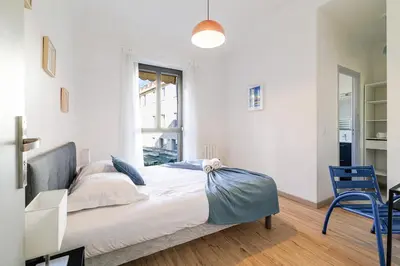 a bedroom with a bed with a blue bow on it at Ultra Central 2 Bdr - AC & Balcony in Nice